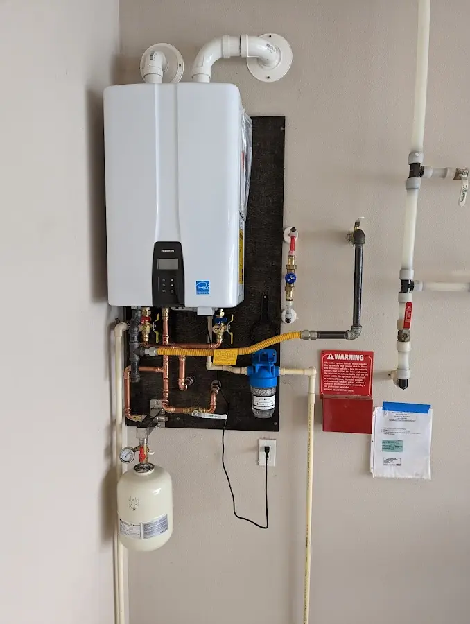 Professional plumber installing copper piping in a Bartlett home